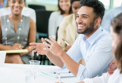 smiling man, talking in business setting